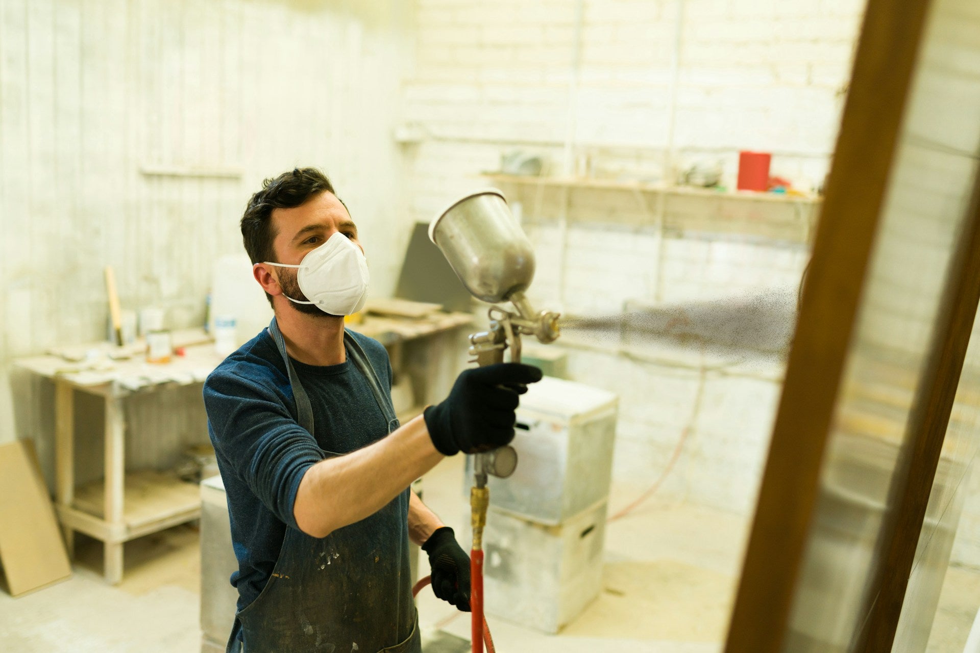 man using a paint sprayer
