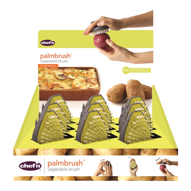 Emery Jensen vegetable brush set with nine yellow and green handheld brushes for cleaning produce.