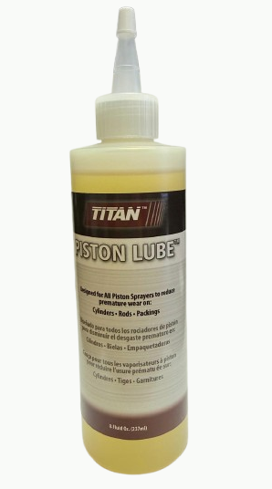 Titan Piston Lube 8oz sprayer accessory, shown in a clear container with nozzle for lubricating pistons and mechanical parts.