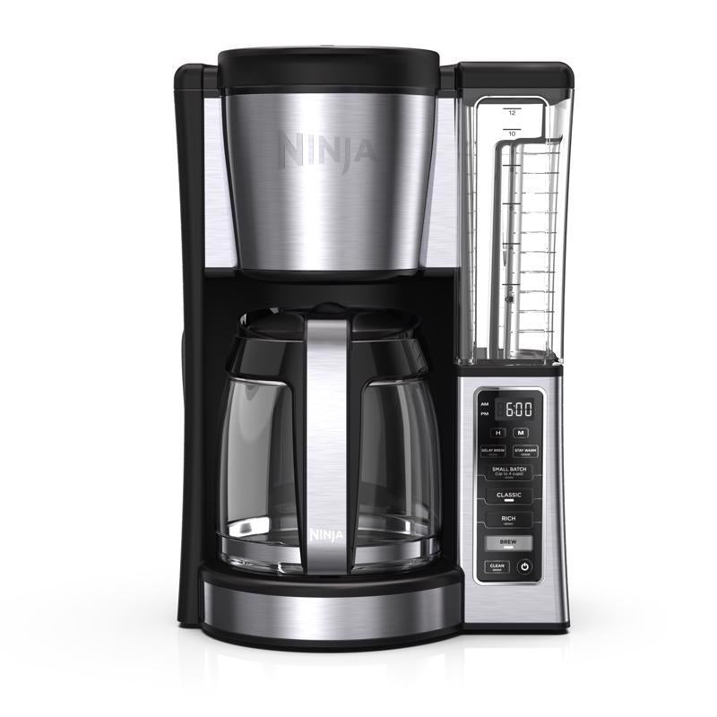 Emery Jensen COFE MKR PRGRM Black 12-Cup Auto Drip Coffee Maker on kitchen counter with glass carafe and control panel.