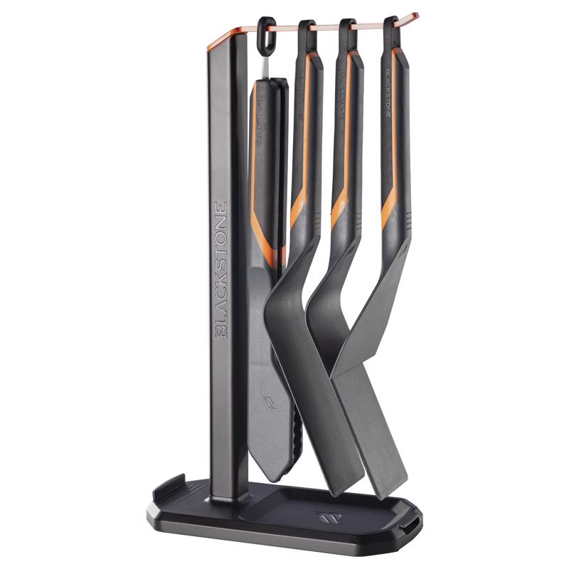 Emery Jensen BBQ tool set with black rubber handles, including tongs, spatula, fork, and brush for grilling.