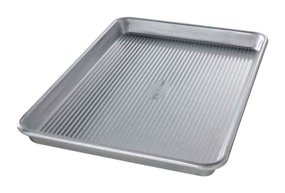 Emery Jensen best tin bakeware jelly roll pan measuring 14.75x9.75 inches, shown in a close-up image with a non-stick surface.