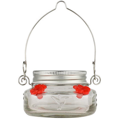 Emery Jensen 6oz bird feeder jar showing clear glass container with metal lid and perch for feeding small birds outdoors.