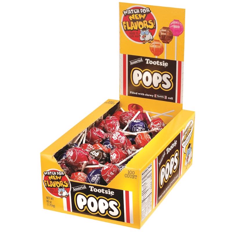 Assorted Tootsie Pops by Emery Jensen featuring colorful lollipops in various fruit flavors, candy and non-chocolate variety.