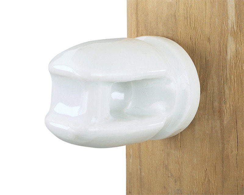 Porcelain insulator for electric fence wire by Emery Jensen, used to insulate and secure fencing wires.
