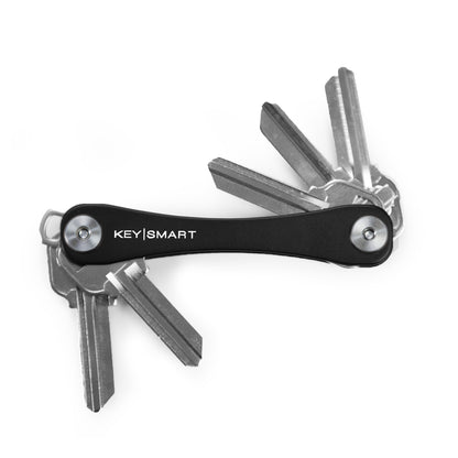Emery Jensen KeySmart key holder in black, showcasing a compact key ring organizer with multiple keys attached.