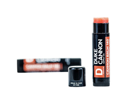 Emery Jensen Duke Lip Balm with orange mint flavor, natural skin care product, showing the balm tube and packaging.