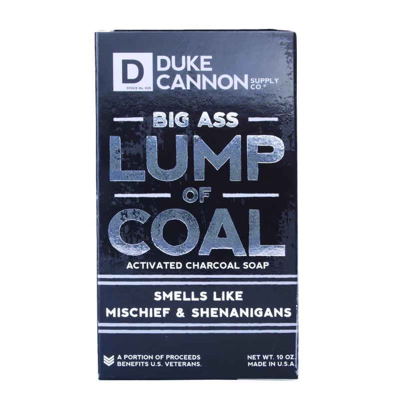 Emery Jensen SHOWR soap lump of coal lip balm and skin care product in a black soap shape with branding label.