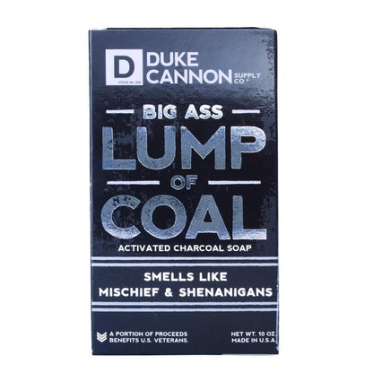 Emery Jensen SHOWR soap lump of coal lip balm and skin care product in a black soap shape with branding label.