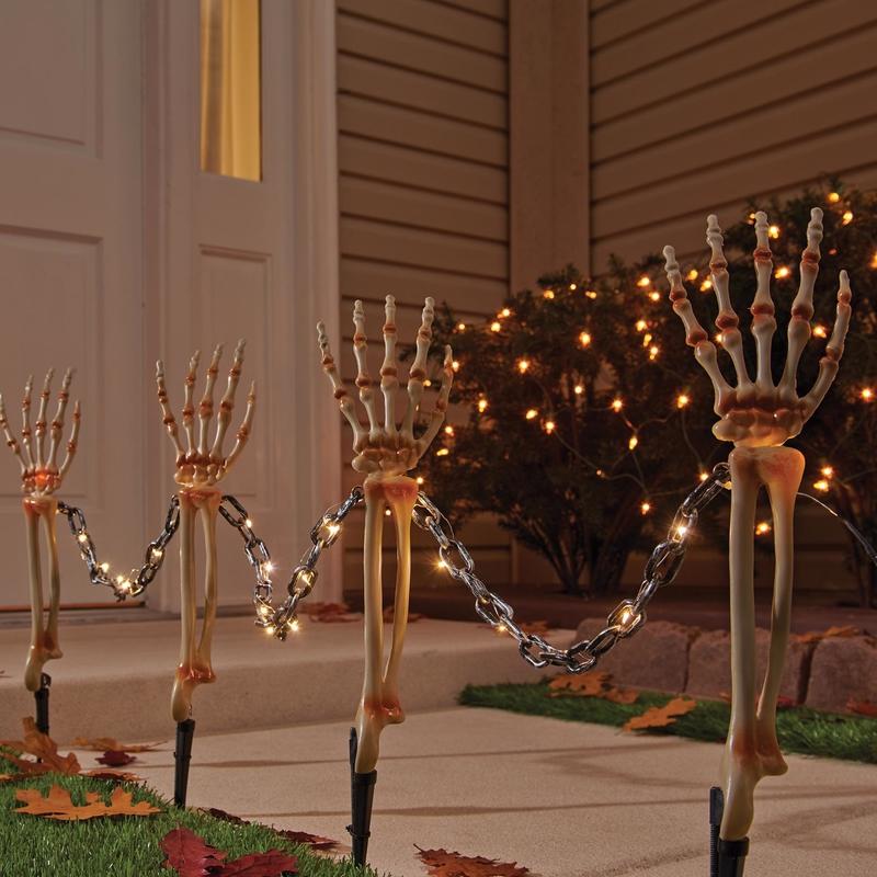 Emery Jensen Skeleton Arms Pathway 4-piece outdoor decoration set featuring spooky skeleton arm figures for Halloween decor.