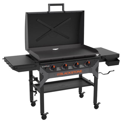 Emery Jensen Black outdoor griddle with four burners, stainless steel surface, and side shelves for outdoor cooking.