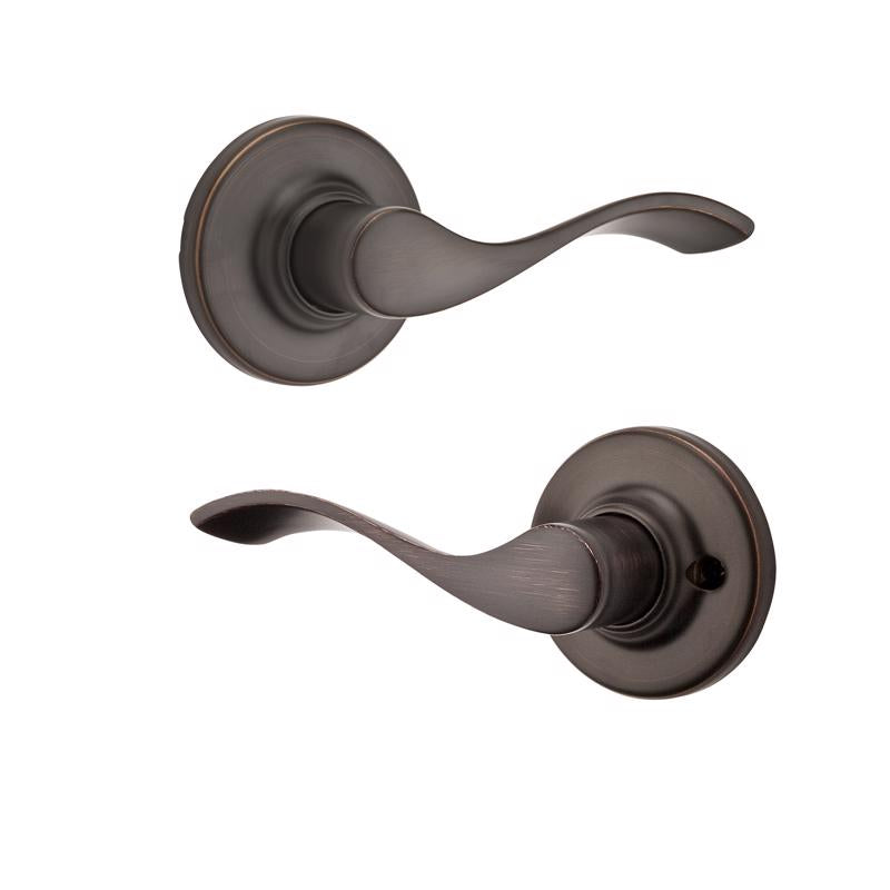 Emery Jensen Passage Lever in Balboa VB, a sleek door handle with a modern design, shown on a door in natural light.