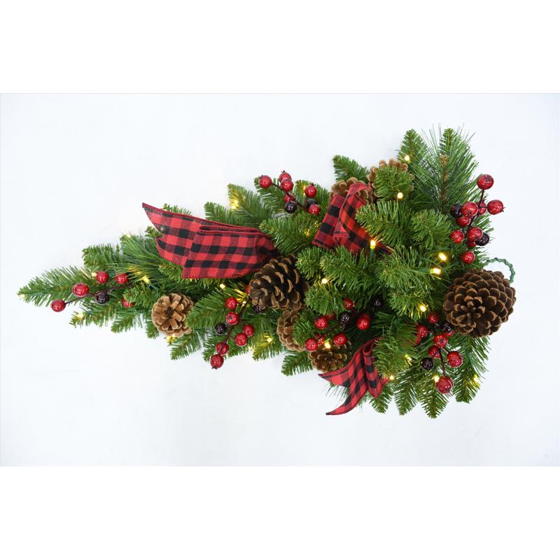 Emery Jensen prelit wreath with twing pine branches, decorated in black and white for festive holiday decor.