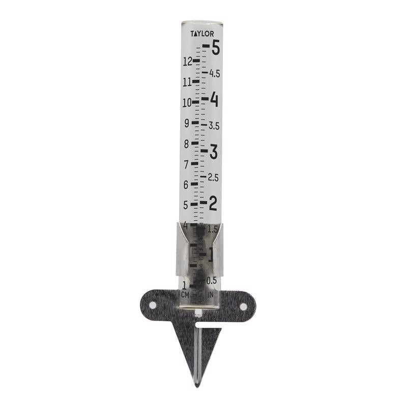Emery Jensen rain gauge with clear glass tube for measuring rainfall, mounted on a metal stake in a garden setting.