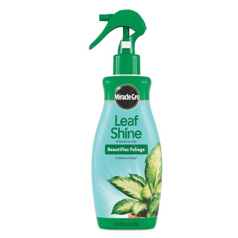 Emery Jensen MG Leaf Shine 8 oz bottle for glossy, healthy plant leaves in a natural setting with green foliage.
