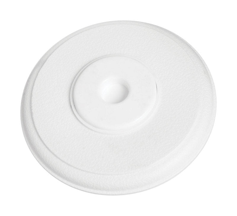 White plastic wall door stop by Emery Jensen, mounted on wall to prevent door damage and hold doors open.