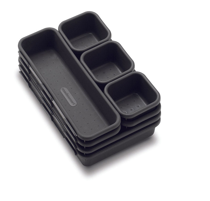 Eight Emery Jensen interlocking storage bins in a drawer organizer for versatile, space-saving organization.
