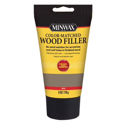 Emery Jensen gray wood filler in a 6oz container, suitable for indoor repairs and wood surface filling.